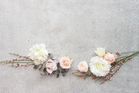 Tender spring flowers on gray background, copy space. Stock Photos