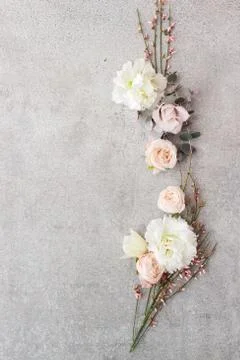 Tender spring flowers on gray background, copy space. Stock Photos