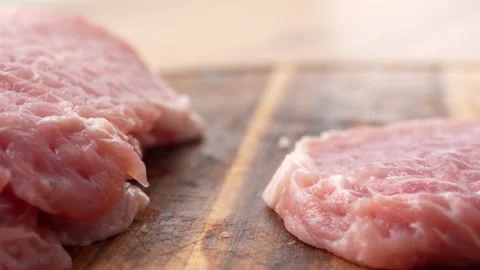 Tenderizing Pork Chops on Wooden Board. Stock Footage 255746053