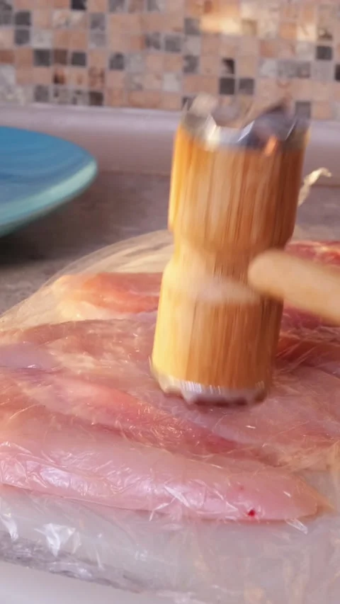 Tenderizing Raw Chicken Fillet With Kitchen Meat Hammer Stock Footage 328355869