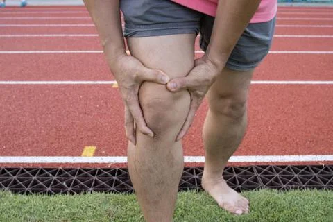Tendon knee joint problems on Man leg from exercise In the stadium. Photos