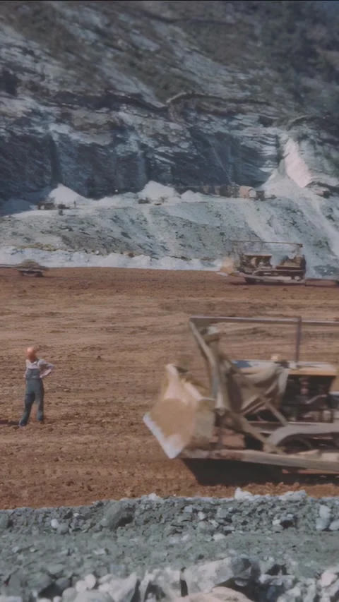 TENNESSEE - 1940s - Workers dump soil and grade it for the bottom of the Watauga Stock Footage 340304937