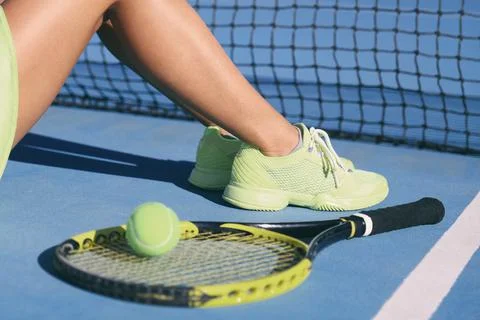Tennis athlete player woman legs and feet wearing tennis shoes trainers. Fashion Stock Photos
