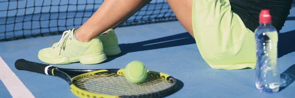 Tennis athlete player woman wearing tennis shoes yellow activewear outfit with Stock Photos