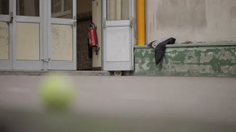 TENNIS BALL IN EMPTY COURTYARD Stock Footage 28012320