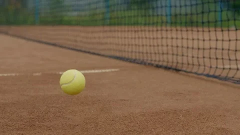 A tennis ball is rapidly approaching the net on a professional clay court during Stock Footage 285605735