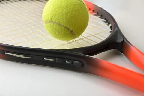 Tennis Ball Resting on Racket Strings Stockfoto's