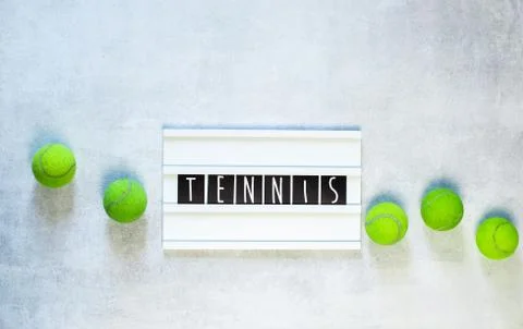 Tennis balls and a racket on white background, with copy space Stock Photos