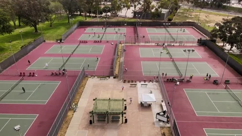 Tennis complex with multiple courts during busy day. Stock Footage 162085605