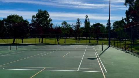 Tennis court wide net green turf blue sky Perth Australia Stock Footage 314251009