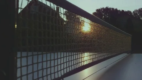 Tennis net close-up with sunset rays in it and on the table. HD, 1920x1080. slow Stock Footage 80859414
