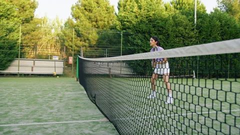Tennis Player Behind The Net Surrounded By Green Stock Footage 278405683