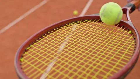 Tennis Player Bouncing Ball on Racket Strings on Clay Court 動画素材 345022686