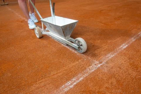 Tennis player indicating or preparing a tennis clay court before her match Stock Photos