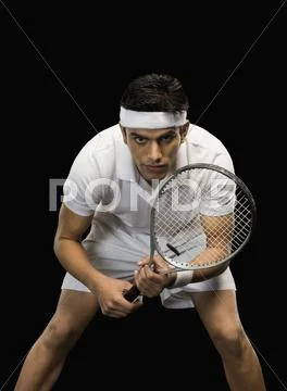 Tennis player practicing with a tennis racket Stock Photos