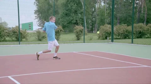 Tennis player uses backhand slice on the half court. Slow motion Stock Footage 58283111