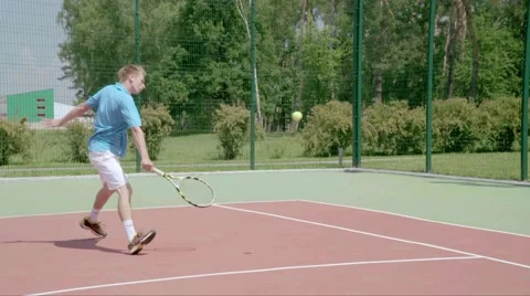 Tennis player uses backhand slice on the half court. Slow motion Stock Footage 58283114