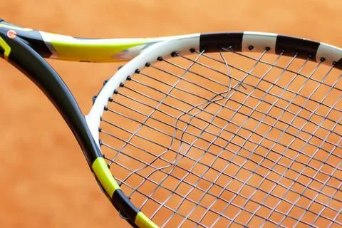 Tennis racket with broken strings. Stock Photos