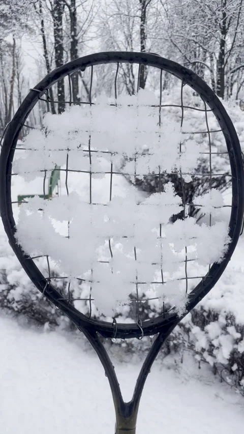 Tennis racket covered with snow Stock Footage 300038058