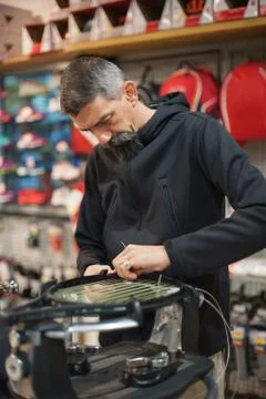 Tennis stringer doing racket stringing Stock Photos