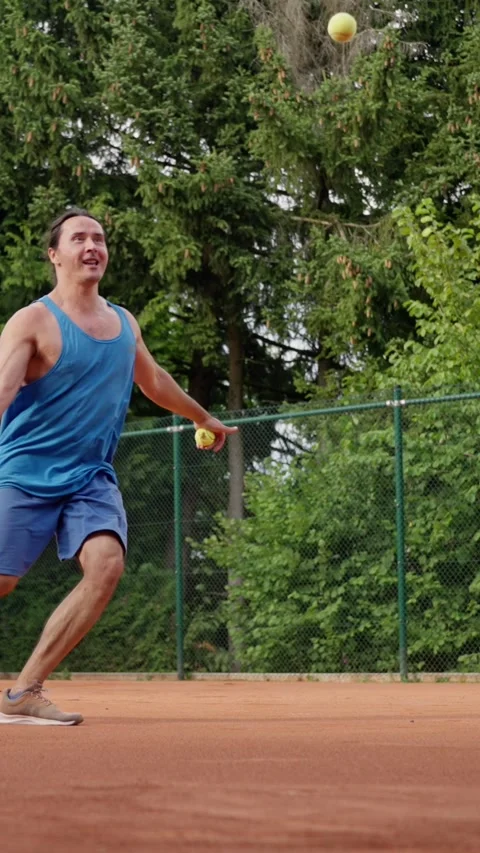 Tennis training session, player executing serve on clay during vigorous practice Stock Footage 321302777