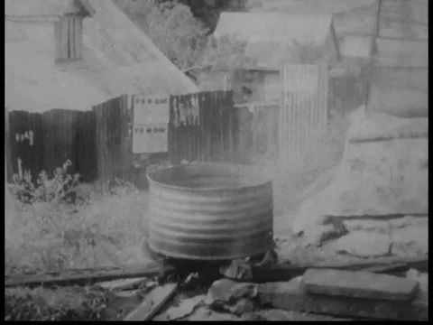 A tenor pan is heated up on a bonfire, and them tuned in a similar way as a Video stock 75304543