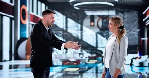 Tense Confrontation Between Boss And Employee In Luxury Hotel Lobby. Stock Photos