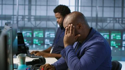 Tense data center admin lightens up after managing to eliminate all errors Stock Photos