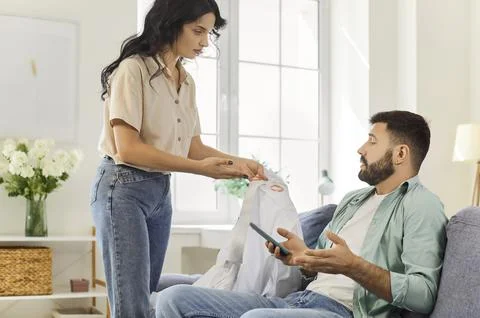 Tense Discussion on Sofa as Lipstick Mark Triggers Relationship Trust Issues Stock Photos