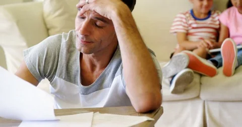 Tense man checking bills in living room Stock-Footage 74219338