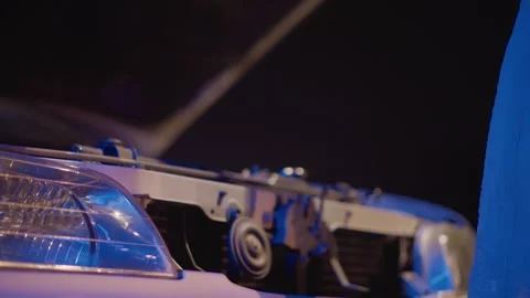 Tense nighttime scene with mechanic testing vehicle latch outside, Male figure Stock Footage 333645549
