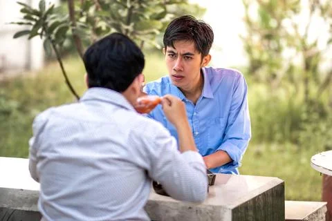In a tense situation between men. at odds with each other. Internal conflic.. Stock Photos