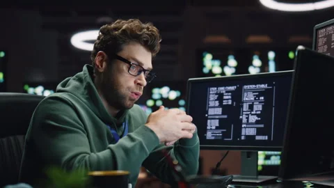 Tensed coder solving problem in dark datacenter closeup. Tired man working late Stock Footage 260260711