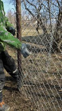 Tension of the galvanized mesh when installing the fence Stock Photos