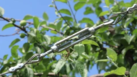 Tensioned cable on the hook. Clamps and tensioning cables. Stock Footage 131716379