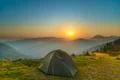 The tent on the background of foggy mountain landscape. Wide angle Photo