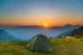 The tent on the background of foggy mountain landscape. Wide angle Photo