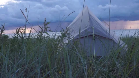Tent on the background of the sea during sunset with rain Stock Footage 206350106