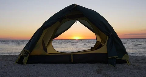 Tent on the beach at sunrise Stock Footage 83574397