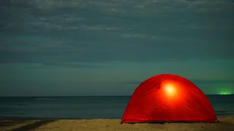 Tent on the beach under moonlight time lapse shot Stock Footage 83372054