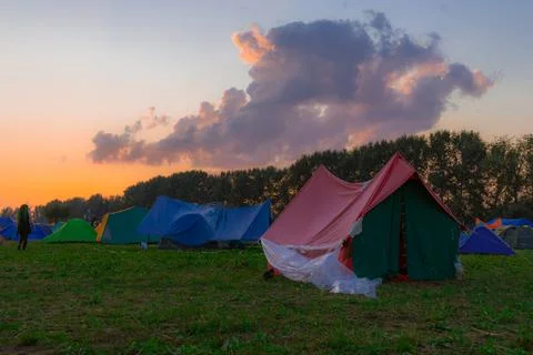 Tent camp of a lot of people in festive outdoor environment space in evening  Stock Photos