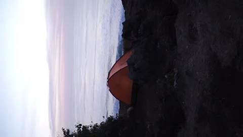 A tent on the edge of a cliff behind (vertical video). Stock Footage 154159969