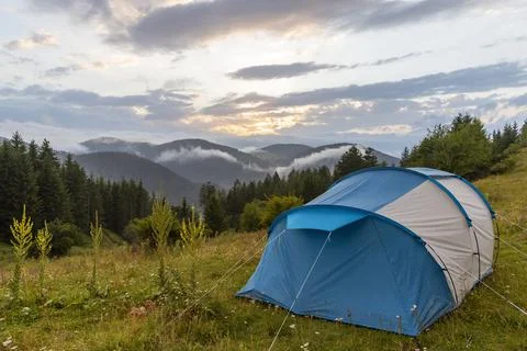Tent in forest meadow. Stock Photos