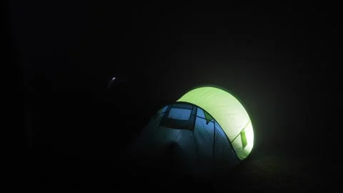 Tent Glowing with Lantern Light During Thunderstorm Stock Footage 292521642