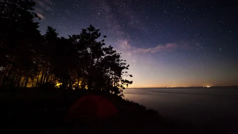 Tent on the lake at night under the starry sky. Timelapse. Stock Footage 135121899