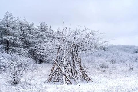 Tent made of thin branches, winter landscape Stock Photos