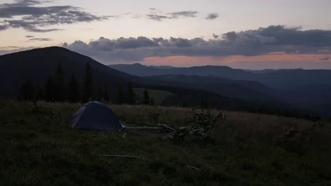 Tent is in the mountains after sunset. wind shakes the grass 스톡 동영상 77570473