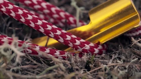 Tent pegs being driven into the ground and guy lines tightened Stock Footage 346639011