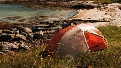 Tent placed on beach at windy sunny day in Lofoten, Norway Video stock 122476558