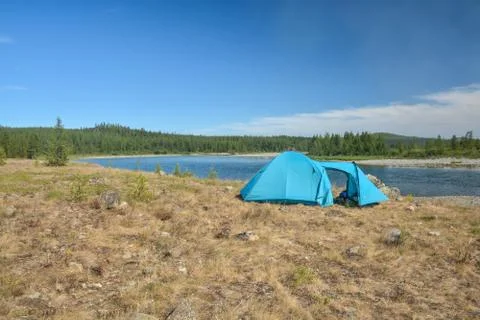 Tent by the river. Stock Photos